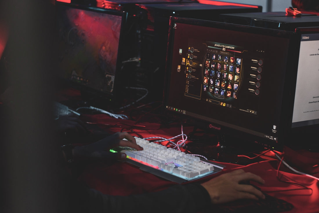a person sitting at a desk with a keyboard and monitor