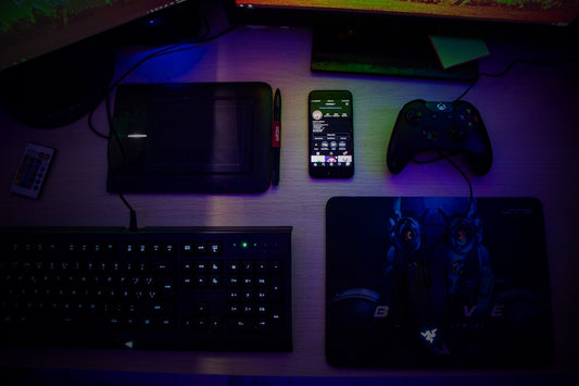 black computer keyboard beside black smartphone