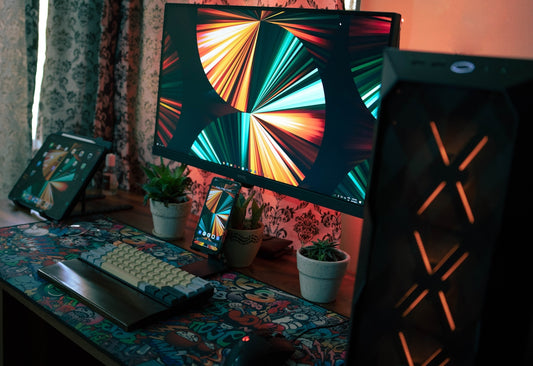 black flat screen tv turned on near black computer keyboard