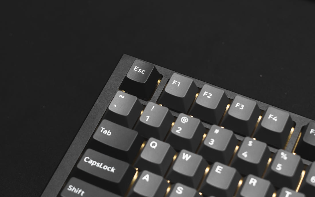 a close up of a keyboard on a black surface