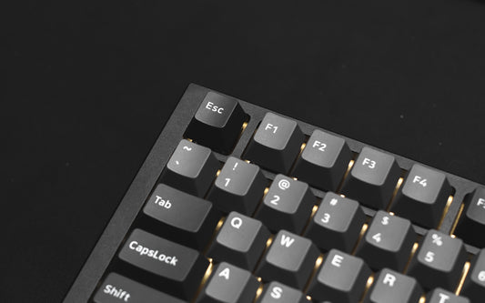 a close up of a keyboard on a black surface