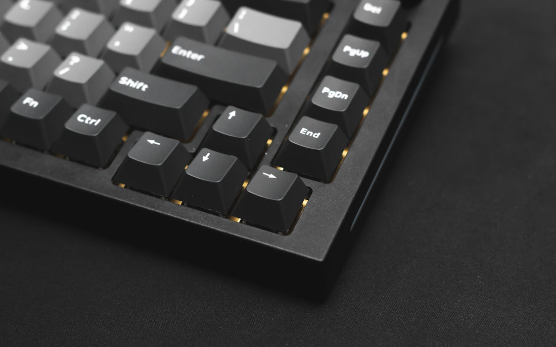 a close up of a keyboard on a black surface