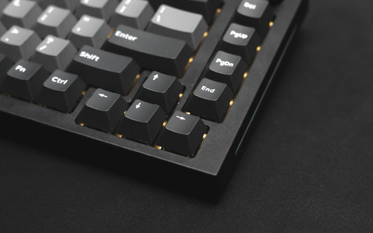 a close up of a keyboard on a black surface