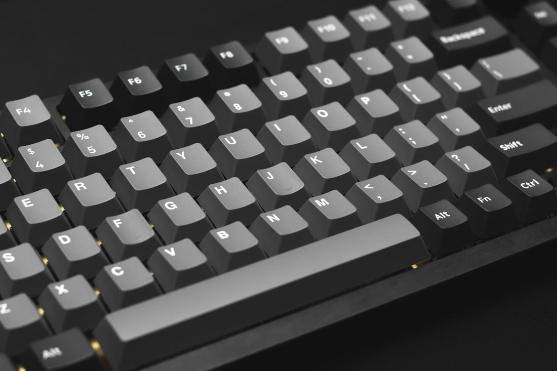 a close up of a keyboard on a black surface