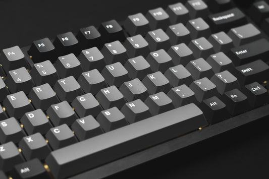a close up of a keyboard on a black surface