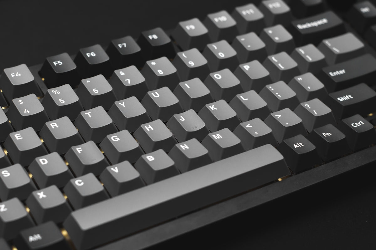 a close up of a keyboard on a black surface