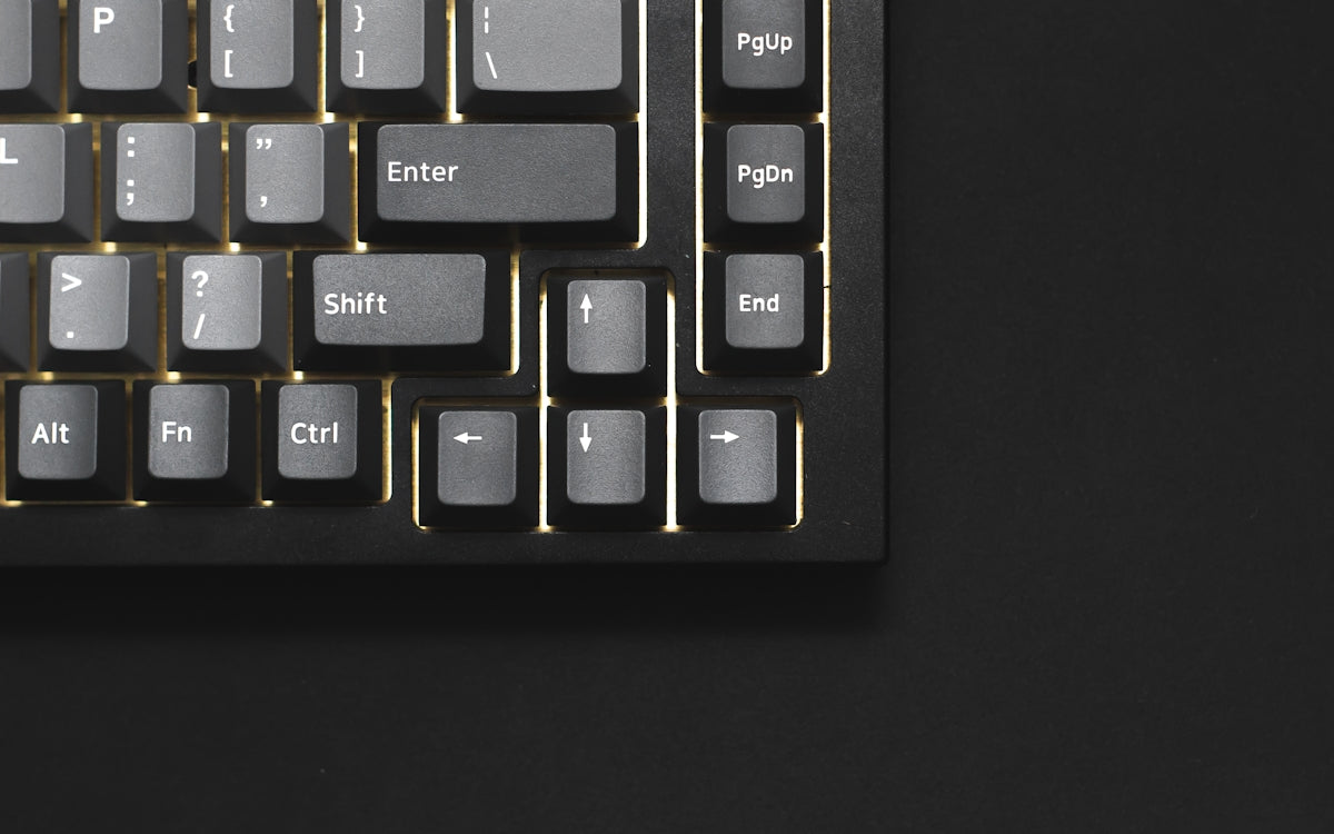 a close up of a keyboard on a black surface