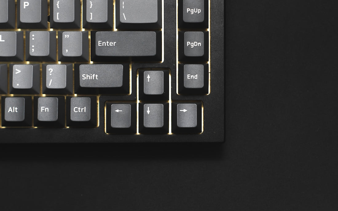 a close up of a keyboard on a black surface