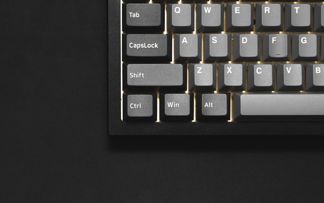 a close up of a keyboard on a black surface