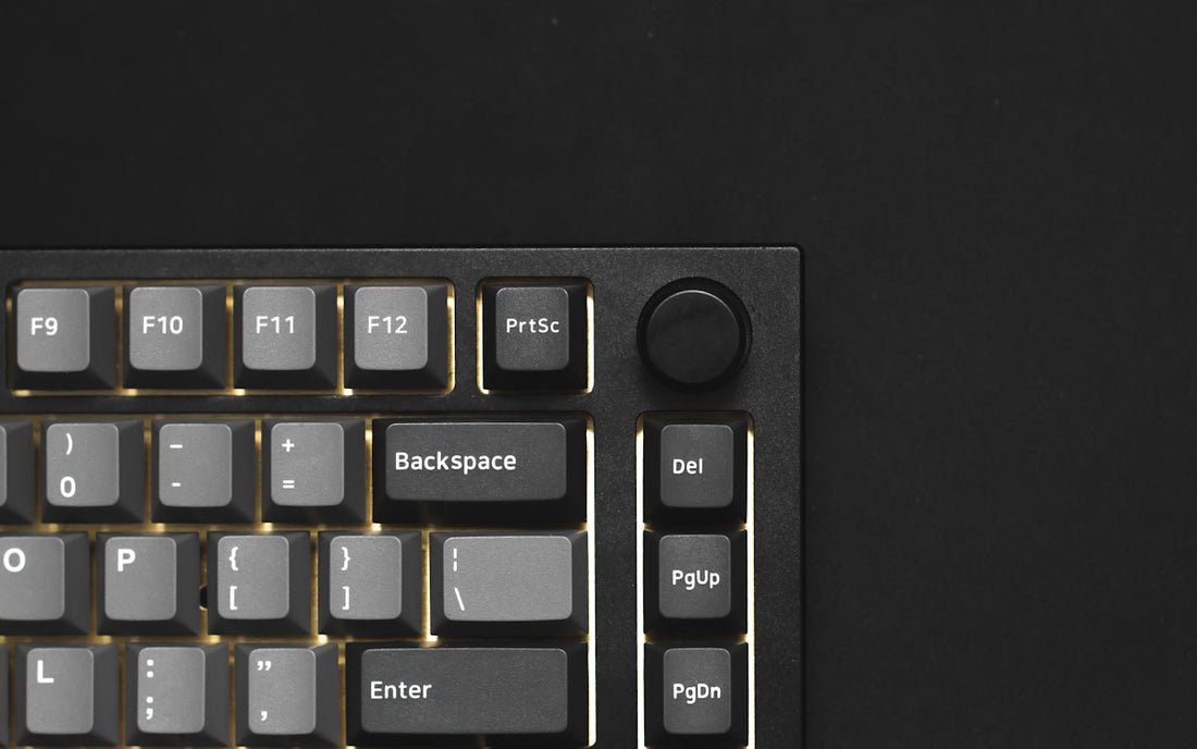 a close up of a keyboard on a black surface