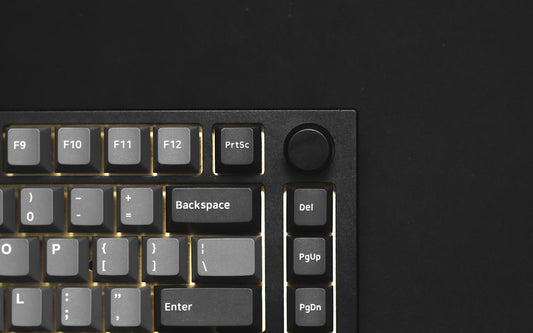 a close up of a keyboard on a black surface
