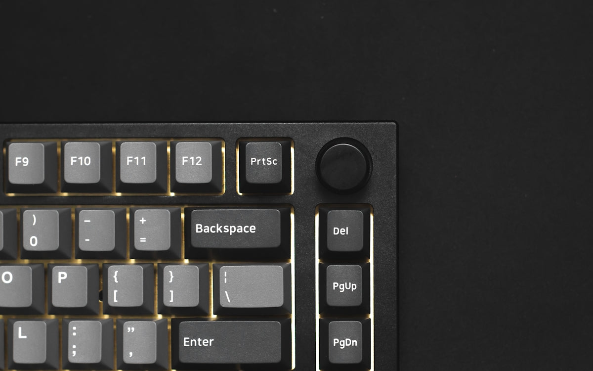 a close up of a keyboard on a black surface