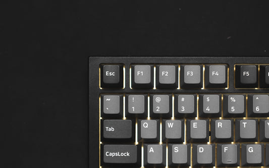 a close up of a keyboard on a black surface