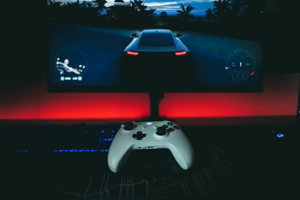 a video game controller sitting in front of a monitor