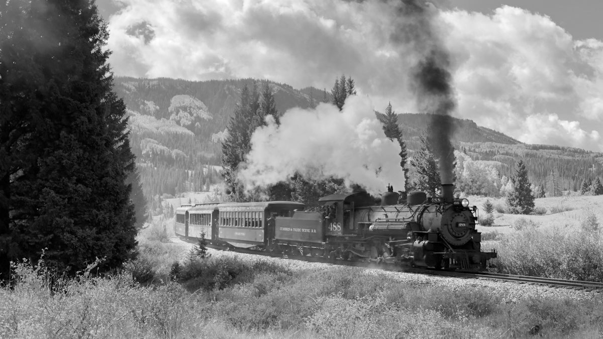 a black and white photo of a train on the tracks