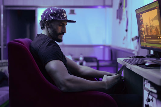 a man sitting in a chair in front of a computer