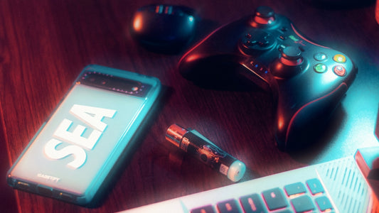 a cell phone, a pen, and a game controller on a table