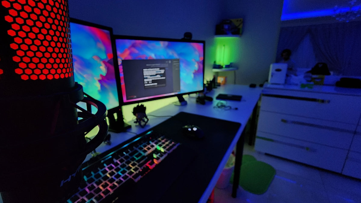a computer desk with two monitors and a keyboard