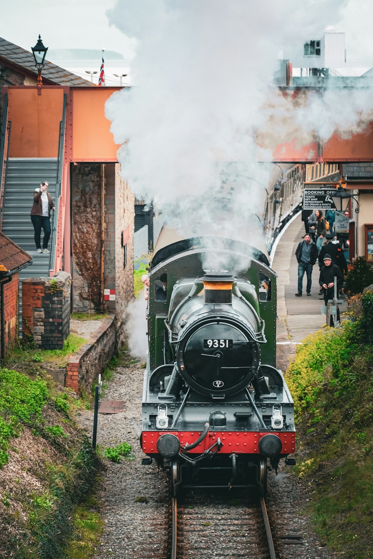 a steam engine train traveling down train tracks