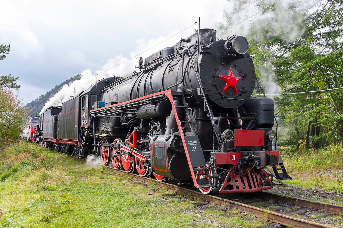 a black and red train traveling down train tracks