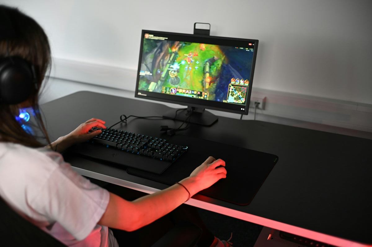 A girl is playing a video game on her computer
