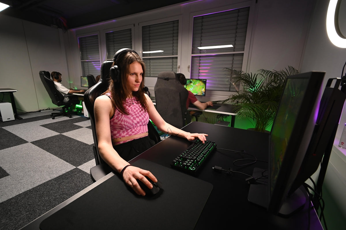 A woman sitting at a desk in front of a computer