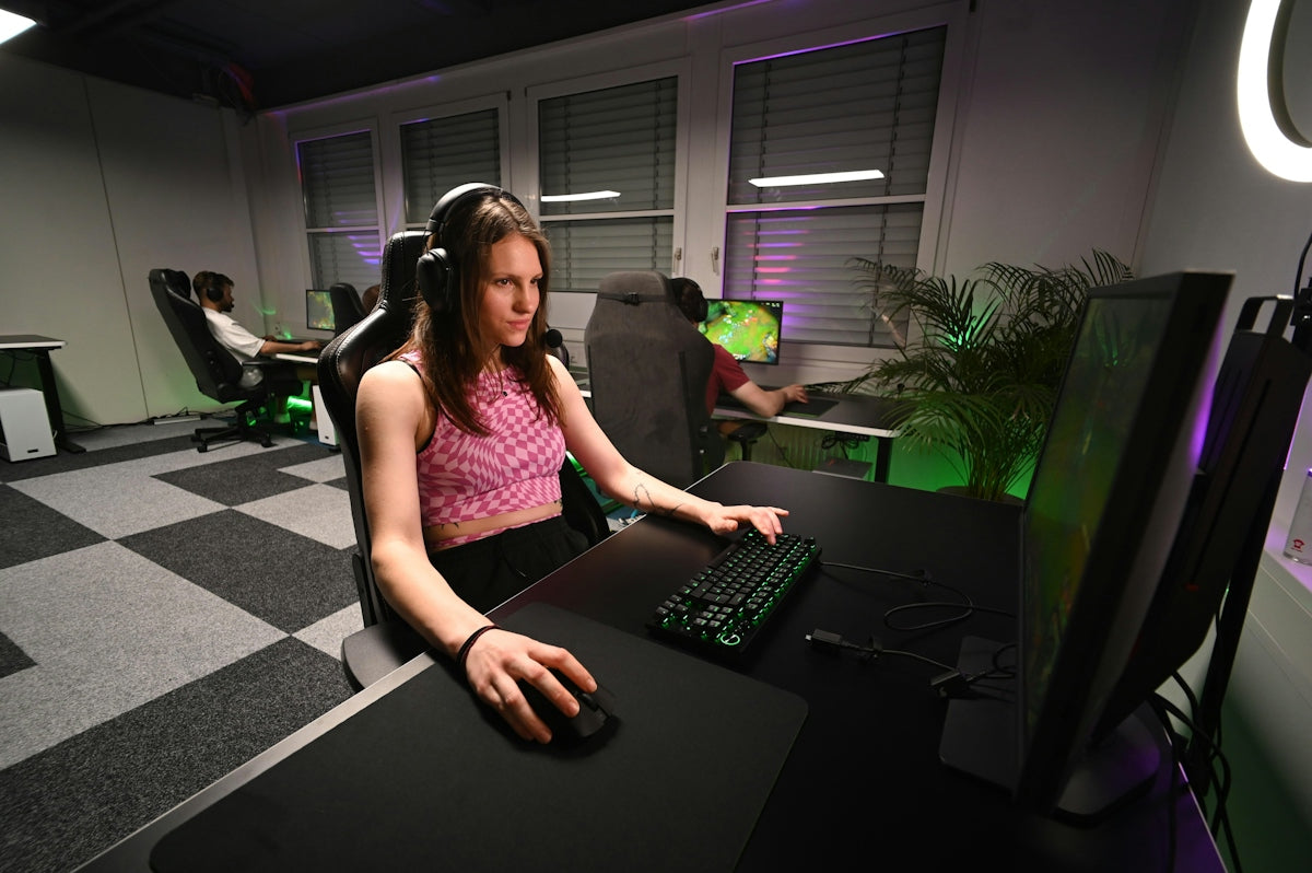 A woman sitting at a desk in front of a computer