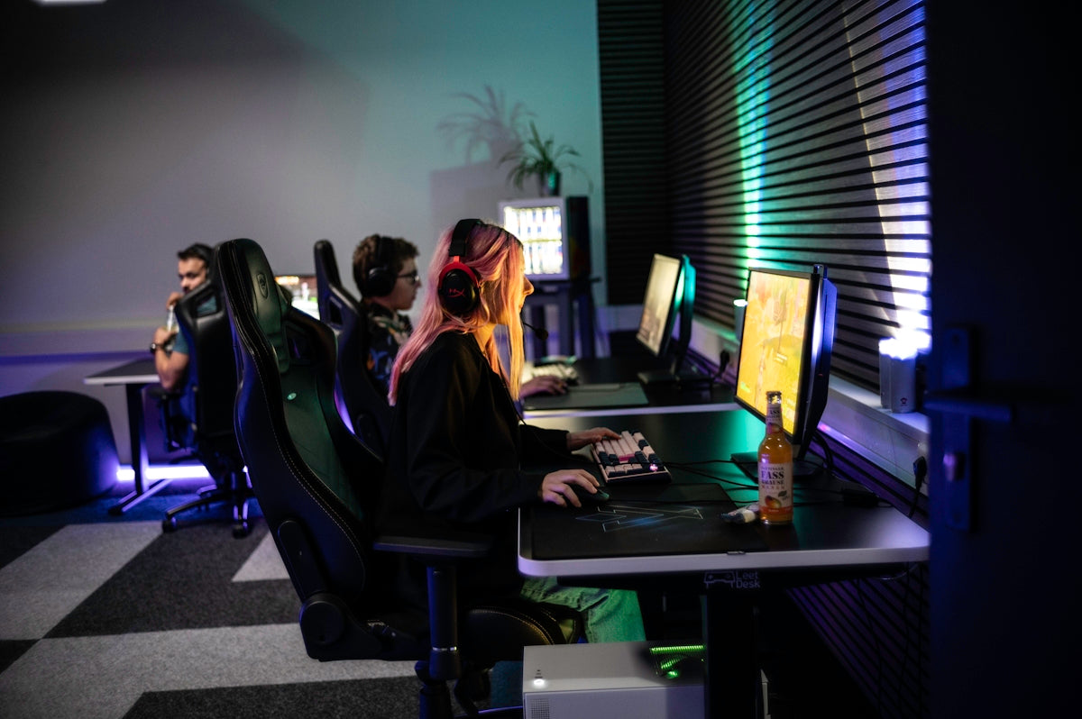 A couple of people sitting at a computer desk