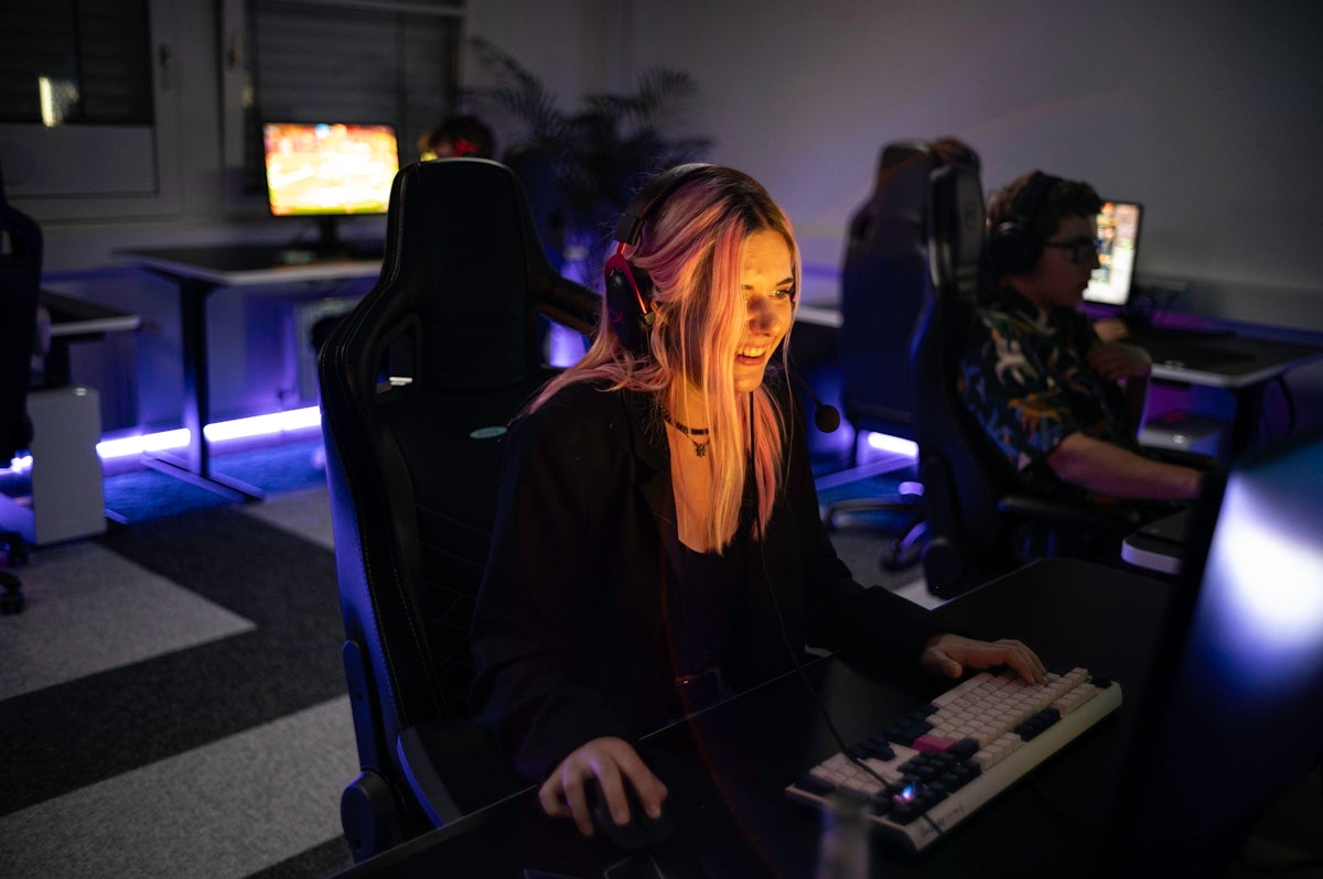 A woman sitting in front of a computer monitor