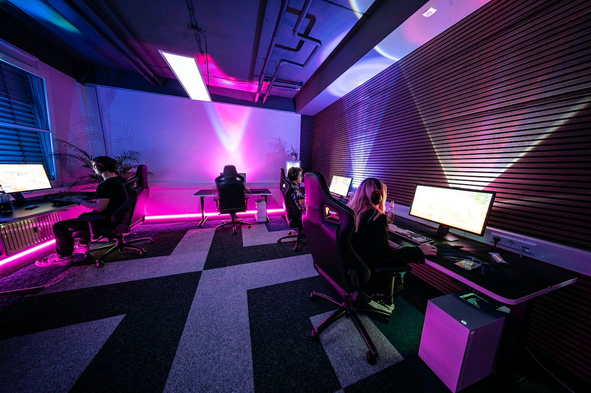 A group of people sitting in a room with computers