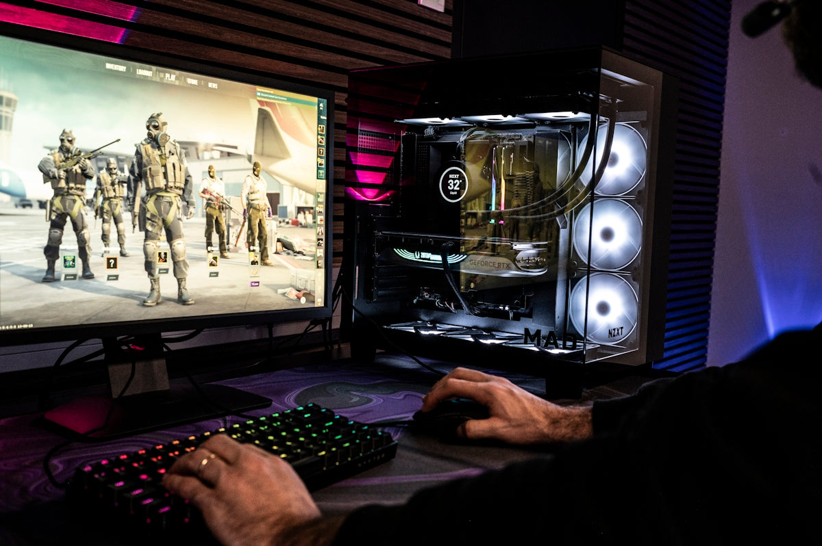 A man is playing a video game on his computer