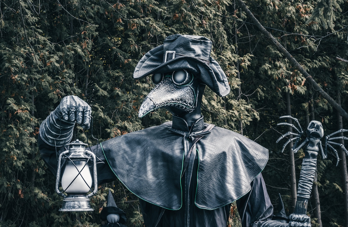 A statue of a man in a costume holding a lantern