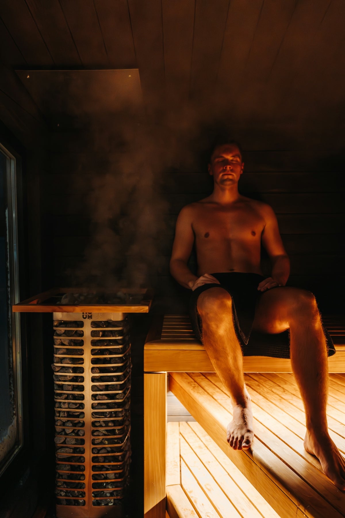 A man is relaxing in a steamy sauna