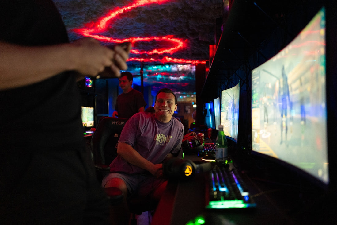 People playing video games in a dimly lit room.