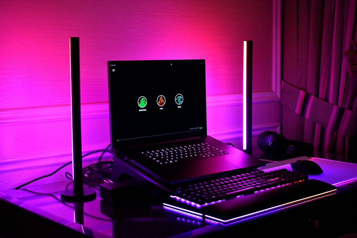 Gaming setup with laptop, keyboard, and rgb lighting